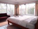 Cozy bedroom with large windows and natural light