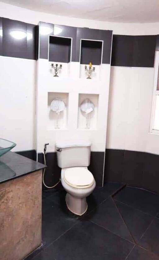 Modern bathroom with dual-tone walls and tiled flooring