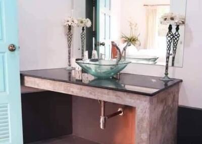 Elegant bathroom interior with glass sink and modern design