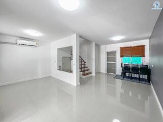 Spacious and modern living room with dining area and staircase