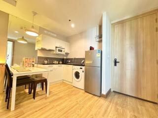 Modern kitchen with integrated appliances and dining area