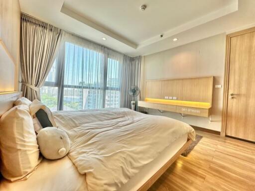 Bright and spacious bedroom with large windows and city view