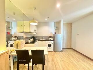 Modern kitchen with combined dining space featuring wooden floors and good lighting