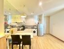 Modern kitchen with combined dining space featuring wooden floors and good lighting