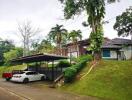 Suburban house with carport and green landscaping