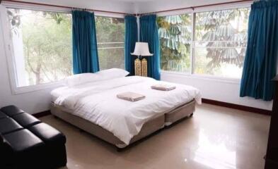 Spacious bedroom with natural light and modern furnishings