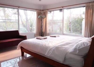 Cozy bedroom with ample natural light and a view of the outdoors