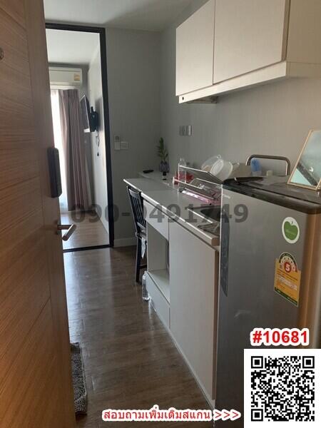 Compact modern kitchen with wood flooring and white cabinetry