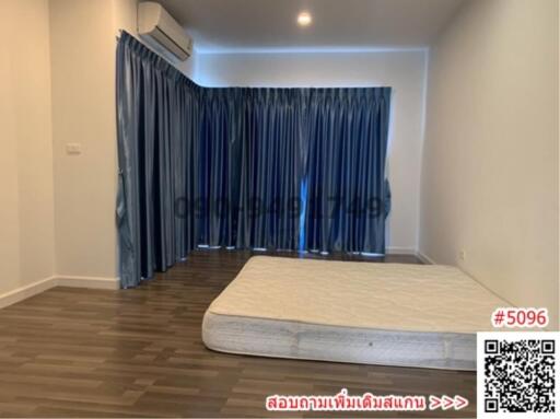 Spacious bedroom with large bed and curtains