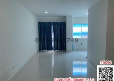 Spacious and bright empty living room with large windows and tiled flooring