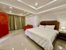 Elegantly furnished bedroom with a large bed and modern lighting