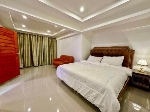 Elegantly furnished bedroom with a large bed and modern lighting