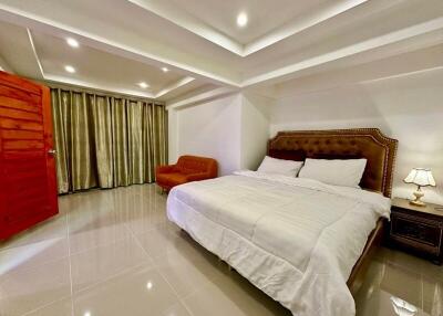 Elegantly furnished bedroom with a large bed and modern lighting