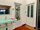 Retro styled bathroom with unique turquoise sink and floral glass door