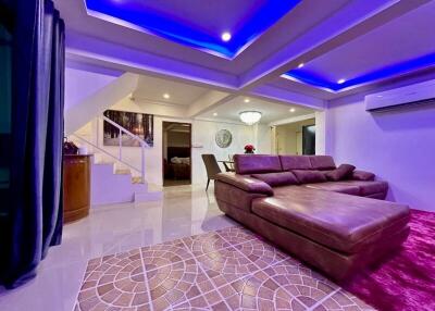 Modern spacious living room with LED ceiling lights and comfortable furnishings