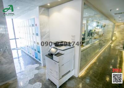 Modern office interior with printer station and glass partitions