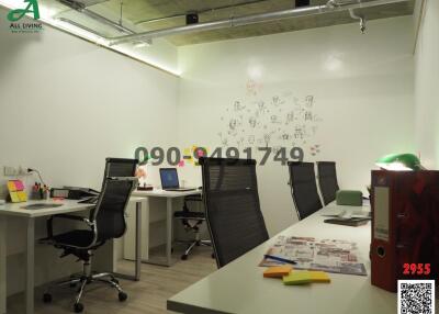 Modern office space with desks and artistic wall doodles