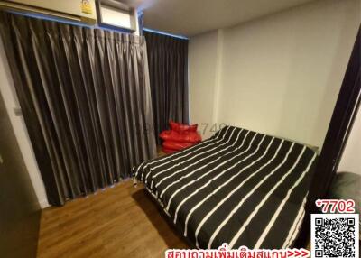 Cozy bedroom with striped bedding and dark curtains