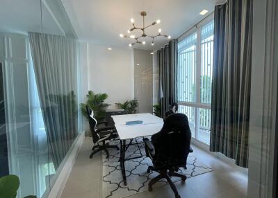 Modern dining room with natural light and chandelier