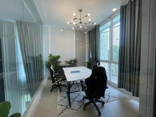 Modern dining room with natural light and chandelier