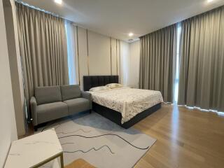 Modern bedroom with a large bed and comfortable seating area
