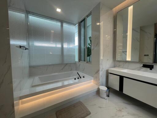 Modern bathroom with marble finishes and a soaking tub