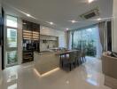 Modern kitchen with dining area, glossy floor tiles, and ample natural light