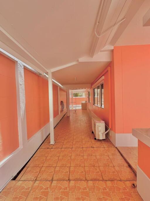 Bright orange interior hallway with terracotta tiled floor