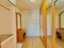 Bright corridor interior with wooden flooring and built-in wardrobes