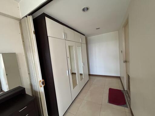Spacious bedroom with built-in wardrobe and mirror