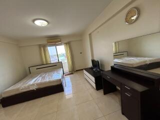 Spacious bedroom with modern furniture and natural light