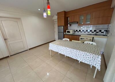 Spacious kitchen with modern cabinetry and dining area