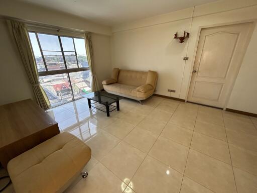 Spacious and well-lit living room with furniture