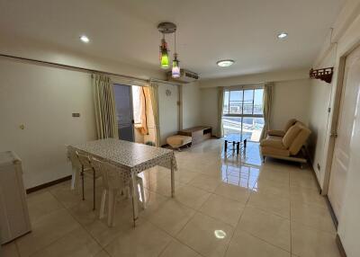 Spacious living room with dining area and tile flooring