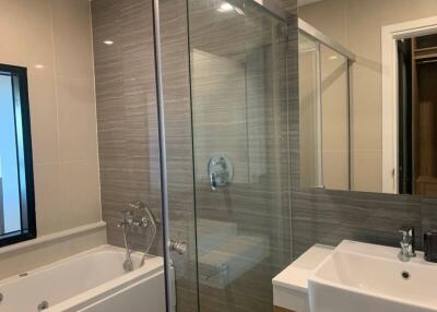 Modern bathroom with separate tub and glass-enclosed shower