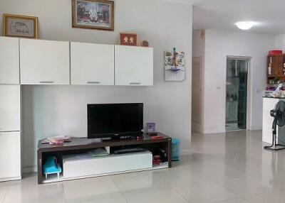 Spacious living room with tiled flooring and modern entertainment unit