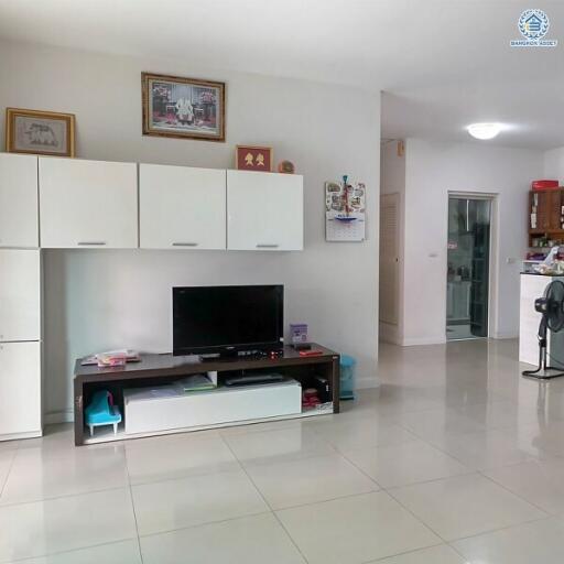 Spacious living room with tiled flooring and modern entertainment unit