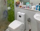 Modern bathroom with green tile accents, well-equipped with toiletries