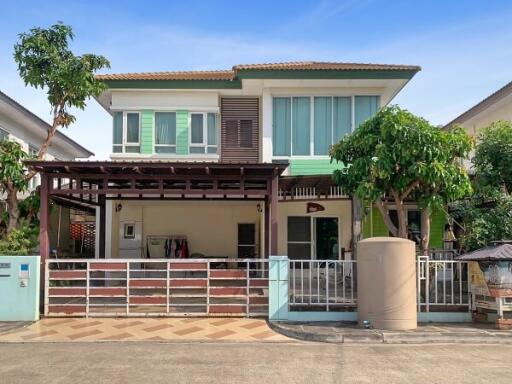 Suburban two-story house with a carport and balcony