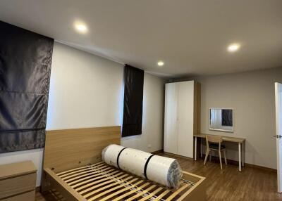 Spacious minimalist bedroom with wooden flooring