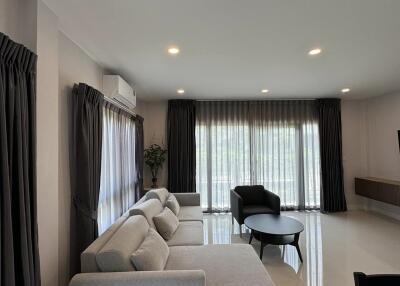 Spacious and elegant living room with modern furniture and ample lighting
