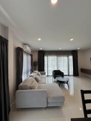 Spacious and elegant living room with modern furniture and ample lighting