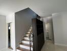 Contemporary staircase with wooden accents and bright interior