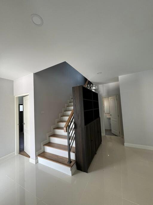 Contemporary staircase with wooden accents and bright interior