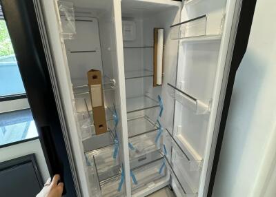 Brand new empty refrigerator in modern kitchen