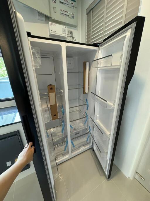 Brand new empty refrigerator in modern kitchen