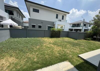 Spacious backyard with well-maintained lawn and privacy fence