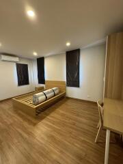 Spacious Bedroom with Modern Furnishings and Hardwood Flooring
