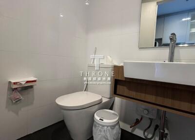 Modern bathroom with wooden vanity and white fixtures