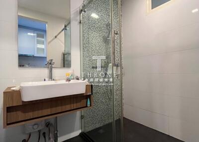 Modern bathroom with shower and wooden accents